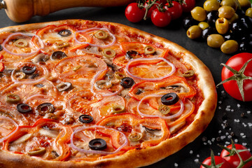 pizza on black background with ingredients