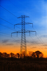 Fototapeta premium Transmission pole against the backdrop of a beautiful sunset