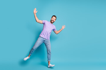 Full length body size photo of young student dancing fooling wearing jeans casual t-shirt sneakers isolated on bright blue color background