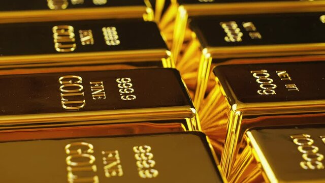 Gold bullion bars seamlessly loop footage. Gold bars stacked in a row. Etching 999,9 Fine Gold, Net WT 1000g engraved into them