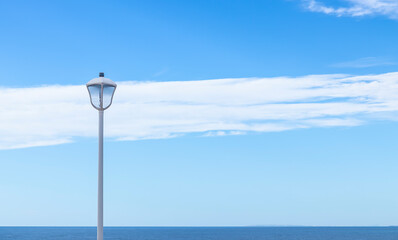 Nice image of a light lantern with a beautiful sky and sea in the background.