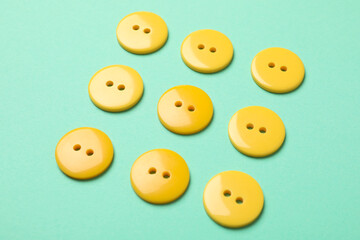 Flat lay with yellow buttons on mint background