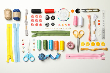 Flat lay with sewing supplies on white background