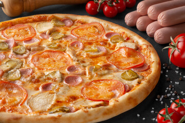 pizza on black background with ingredients