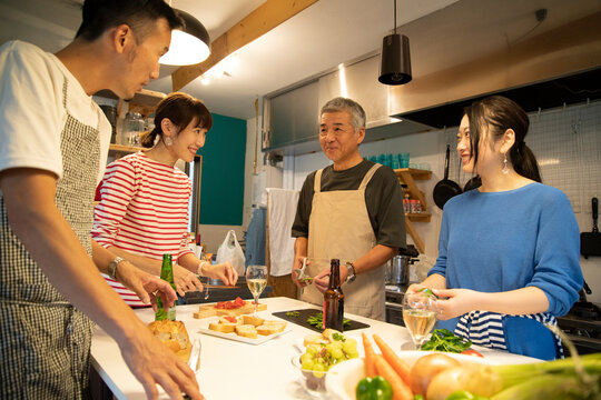 Men and Women Cooking in the Shared Kitchen