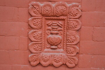 A design in a wall outside of a hindu temple in Kathmandu, Nepal.