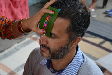 A HIndu person takes 'tika' on the occasion of 'Bhaiyadooj'