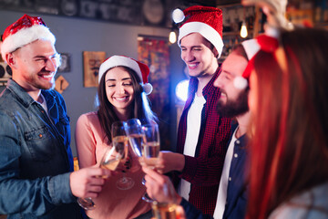 Group of happy friends celebrating  new year's party.  A crowd of young  people with sparklers, gifts and clinking glass. Party, holidays,  nightlife, holidays. Christmas.