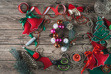 handmade Christmas decor with felt, pine cone,candles on the wooden table.