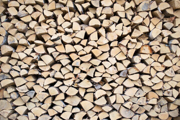 Birch firewood. Front image of cuts of firewood. The wood is dry and ready to light the fireplace. Wood background