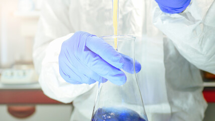Close-up of the hands of a scientist doing a laboratory experiment. Research concept. Selective focus.
