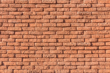 Red brick wall background inside of the room.