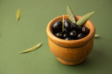 black olives, on green background