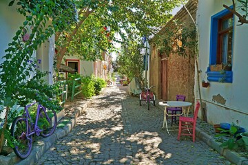 View of narrow and colorful street of Bozcaada located in Canakkale, Turkey.