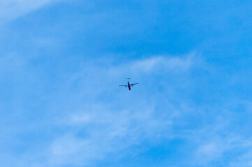 Fototapeta na wymiar An airplane flying in the blue sky