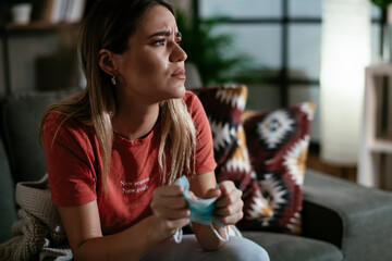 Young woman waiting results from the laboratory. Worried woman waiting Covid-19 test.