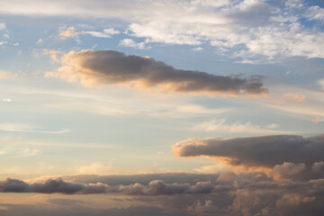 Fototapeta na wymiar Dramatic big clouds in the vast sunset sky