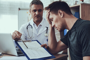Man grabbed his head while looking at the invoice.