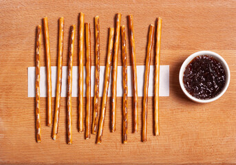 Whole grain bread sandwiches with ricotta cheese, tomato, arugula. On a wooden board. White background.
