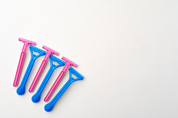 Pink and blue razors on white background