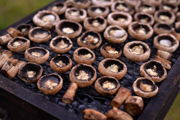 grilled mushrooms stuffed with cheese. vegan food prepared in the garden