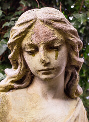 Woman angel crying in the cemetery. Death and suffering