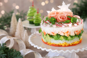 Christmas layered salad with salmon, avocado, shrimp, and vinegared rice on holiday decoration table.　ケーキ寿司　クリスマス