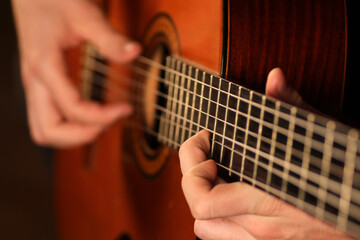 Fototapeta na wymiar Person playing classic acoustic guitar