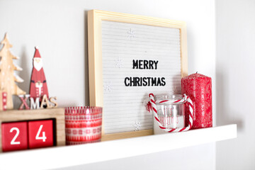 Christmas decoration collection on shelf in bedroom or living room. Christmas red holiday decor