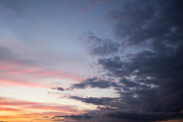 Fototapeta na wymiar Dramatic big clouds in the vast sunset sky