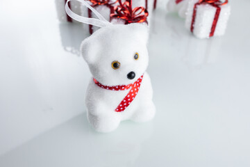 Christmas tree toy white bear near Christmas gift boxes with ribbon