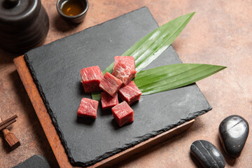 Fresh raw beef brisket slice set on the black marble dish rock. healthy and raw food concept