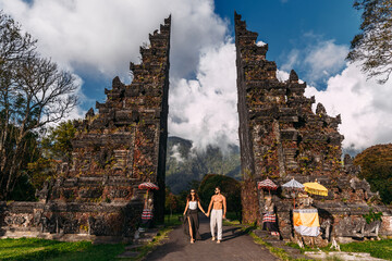 Beautiful couple at the Baltic temple. Man and woman traveling in Indonesia. Couple at the Bali...