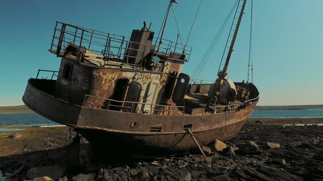 Abandoned ship on the shore of the Barents sea on the Rybachy Peninsula, Russia. Smooth camera movement.