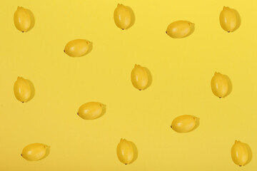 lemons on yellow background flat lay