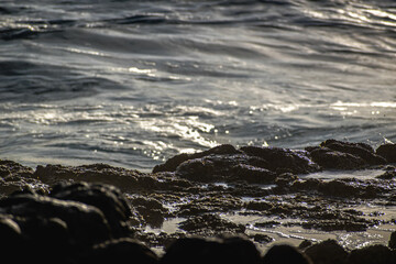 Gentle waves hitting the rocks