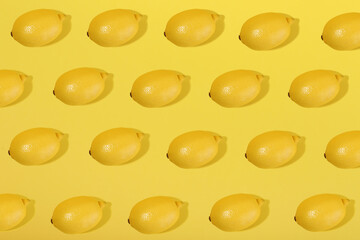 lemons on yellow background flat lay