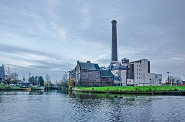 Leiden, The Netherlands, November 14, 2020: view across the city's ramparts canal towards the power...