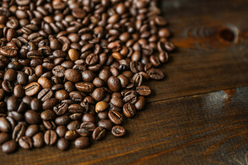 roasted coffee beans on dark wooden background