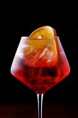 glass of aperol spritz cocktail on a black background close up