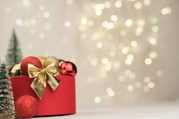 Christmas background , red round gift box with a Golden bow on the background of star gold bokeh....