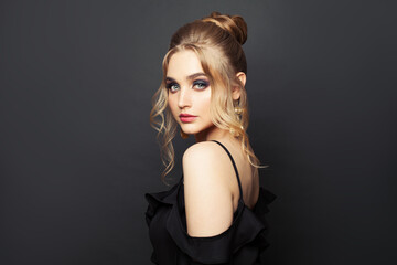 Perfect blonde woman on black background