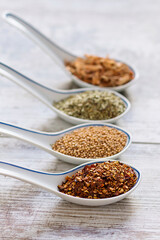 Fine spices and herbs in chinese porcelain spoons