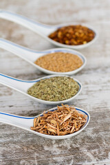 Fine spices and herbs in chinese porcelain spoons