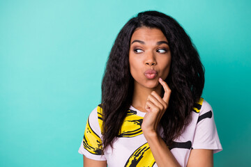Photo of pretty black girl finger cheekbone look side empty space lips wear banana print t-shirt...
