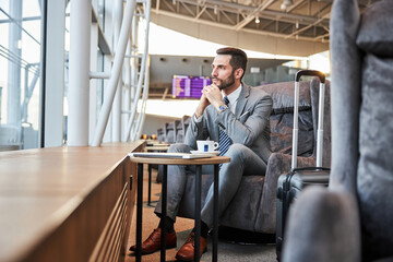Business executive contemplating something while looking at the window