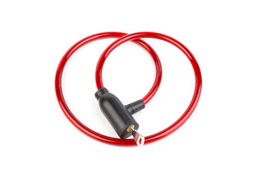 Flexible red bicycle cable with key on white background.  Security and safety concept.