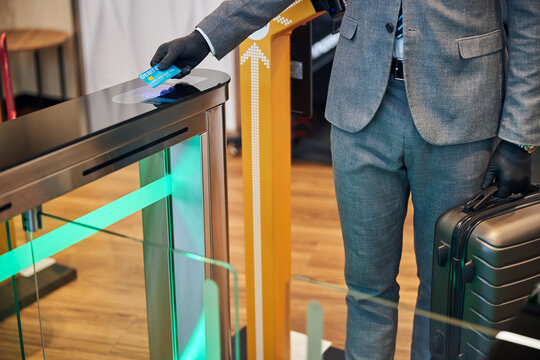 Business Official Coming Through A Swing Turnstile Gate