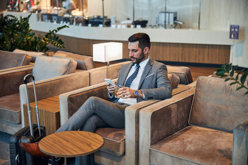 Business owner sitting with whisky and phone