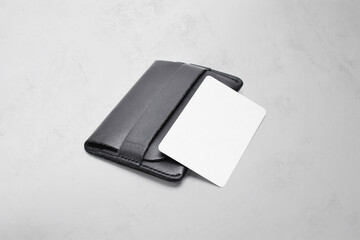Black leather card holder with blank white card mock up isolated. Business credit cards mockup in sleeve cardholder pocket. Clear paper visiting id cards in grey wallet box. Logo design presentation.